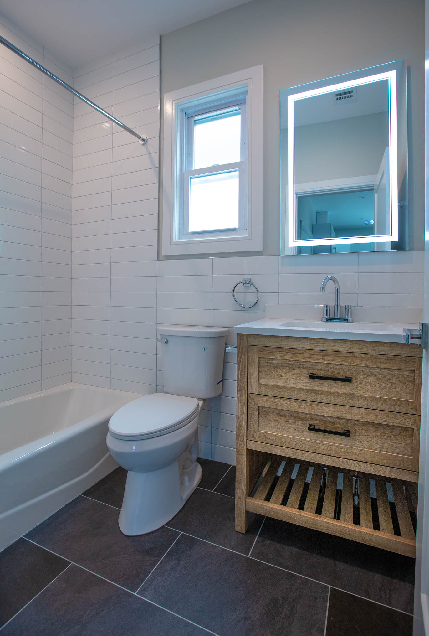 Luxury bathroom remodel with large-format tile and glass shower in Manhattan